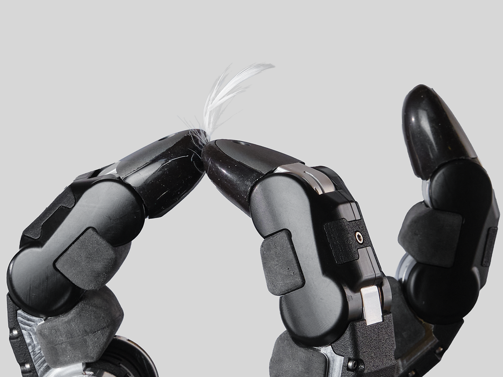 A robotic hand holding a feather, showcasing advanced technology and precision in design.